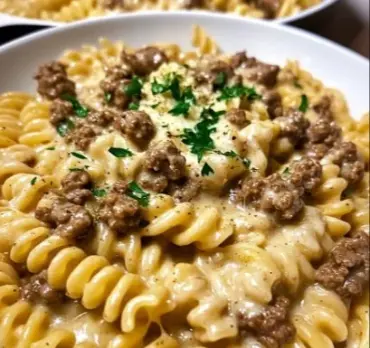 Plate of Beef Rotini in creamy garlic Parmesan sauce garnished with parsley