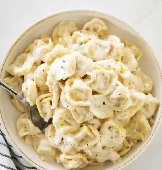 Delicious Chicken Tortellini Alfredo topped with parmesan cheese