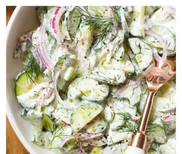 Creamy Greek cucumber salad with fresh vegetables and herbs