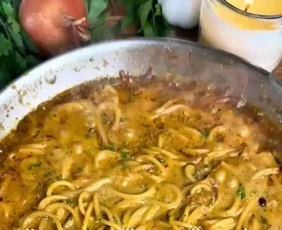Delicious creamy pasta dish topped with grated cheese and herbs