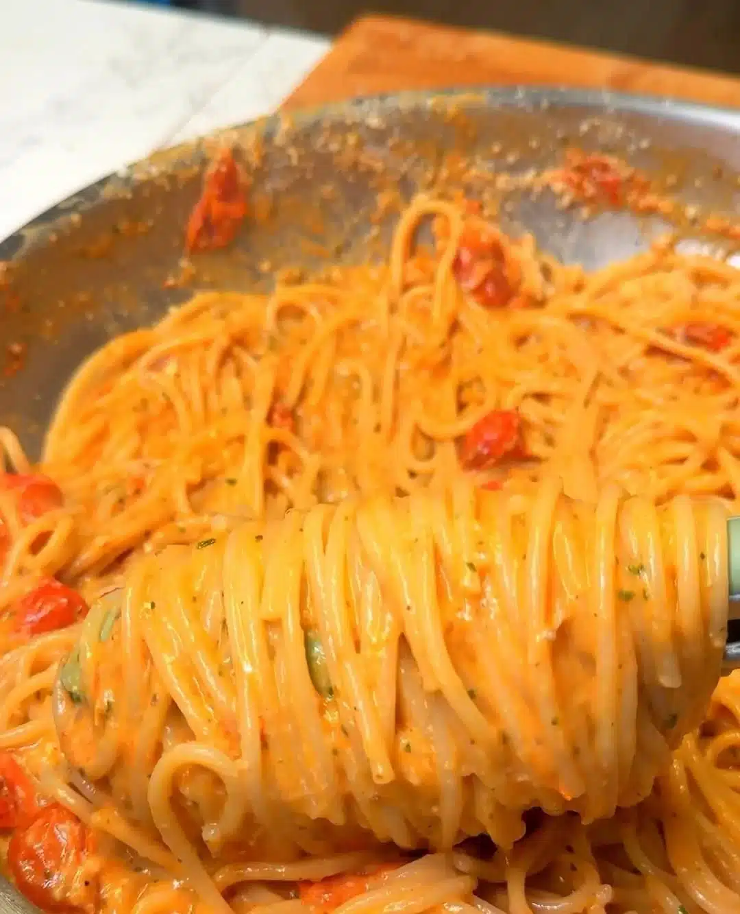 Creamy roasted tomato garlic pasta served in a bowl, garnished with fresh herbs.