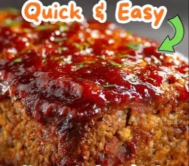 Delicious glazed meatloaf served on a plate with a savory glaze and herbs.