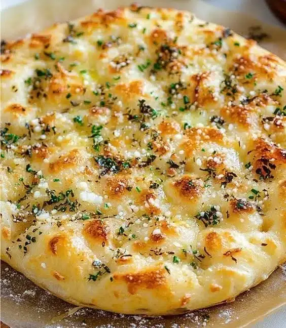 Delicious homemade Garlic Parmesan Focaccia bread topped with melted butter and herbs.