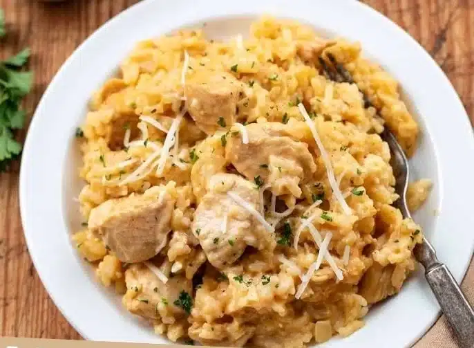 Garlic Parmesan Chicken & Rice dish served in a bowl with garnishes.