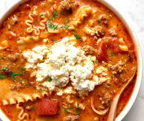 Delicious bowl of homemade lasagna soup topped with cheese and herbs