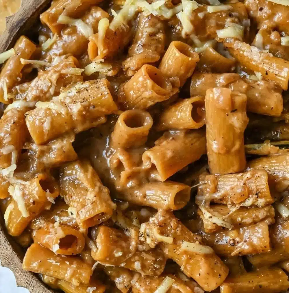 One Pot French Onion Pasta topped with melted cheese and caramelized onions