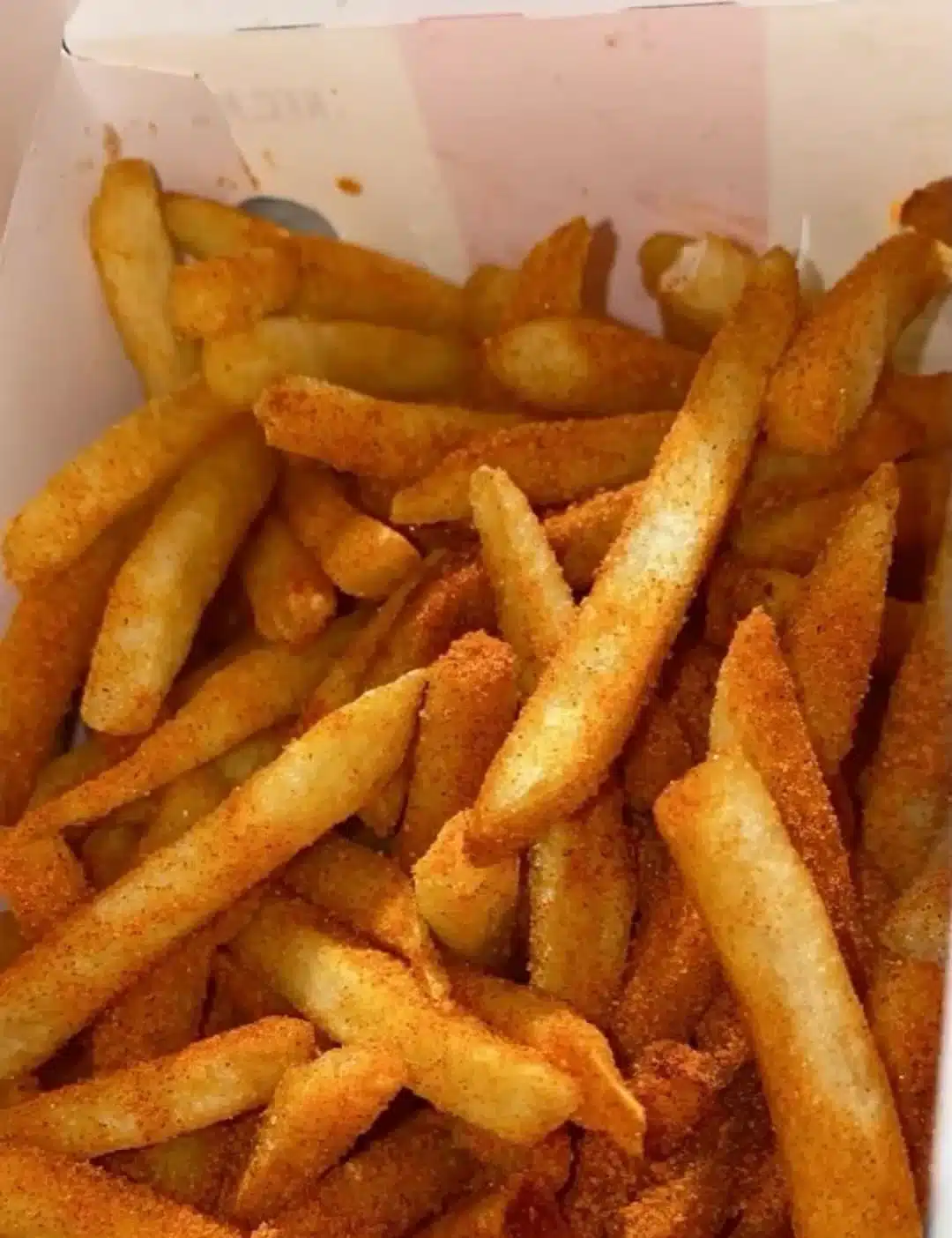 Plate of flavorful spicy fries, seasoned for an extra kick.
