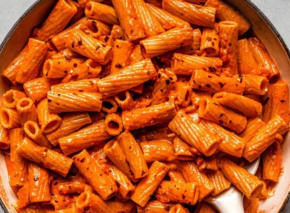 Creamy spicy pasta in Cajun cream sauce garnished with herbs